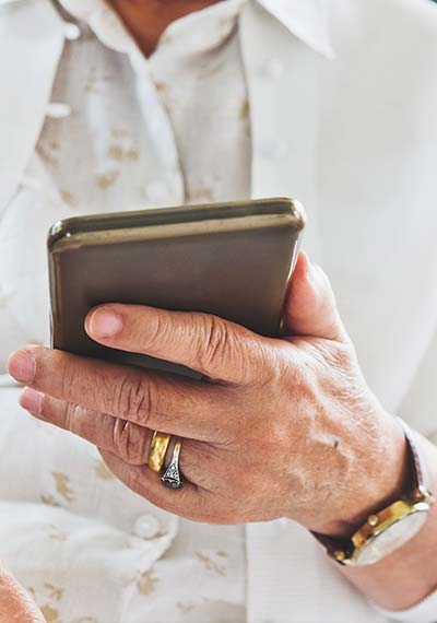 senior holding mobile phone